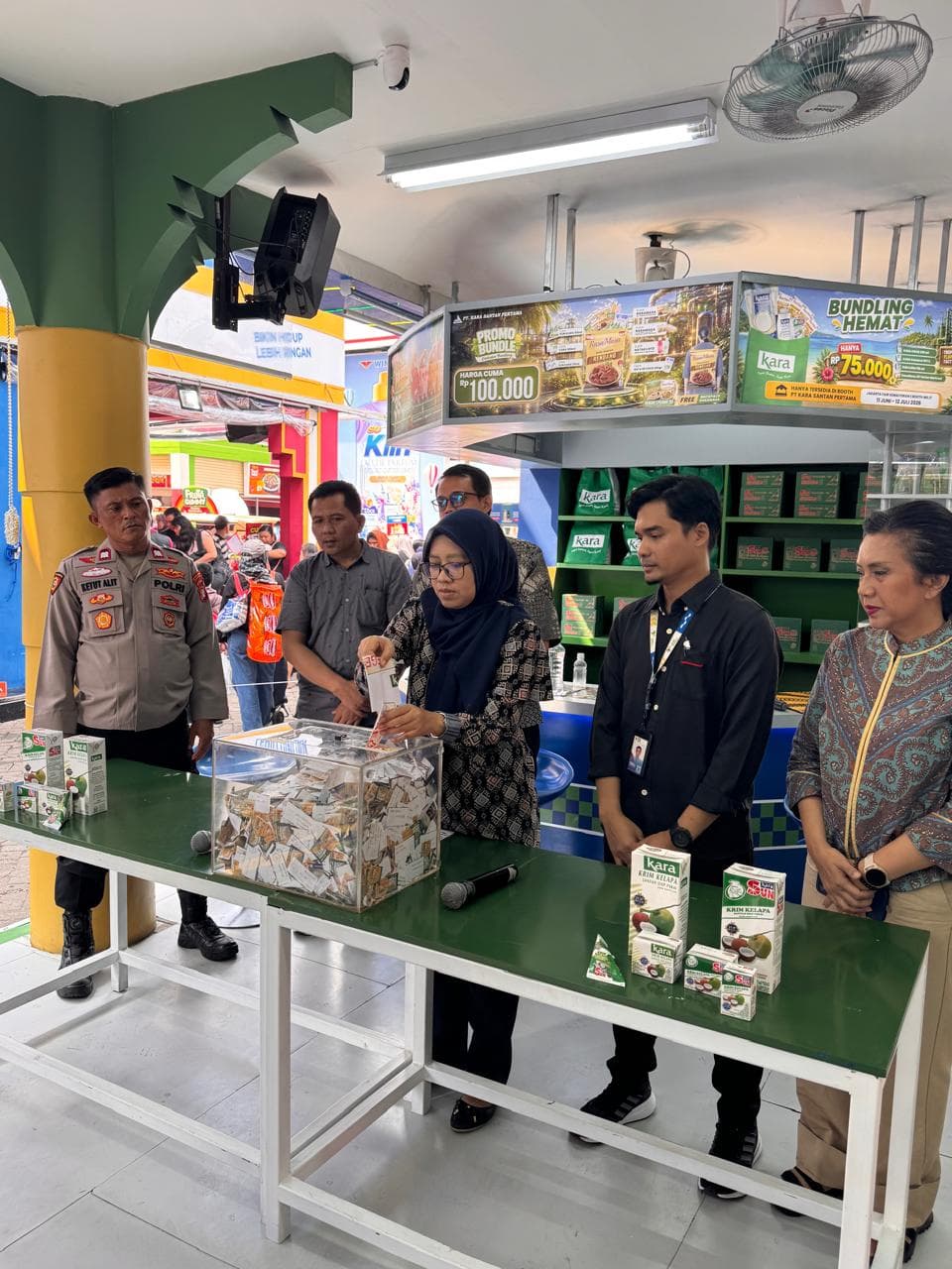 Pengundian kupon undian ditarik dari kotak transparan, disaksikan aparat dan tim di booth Jakarta Fair